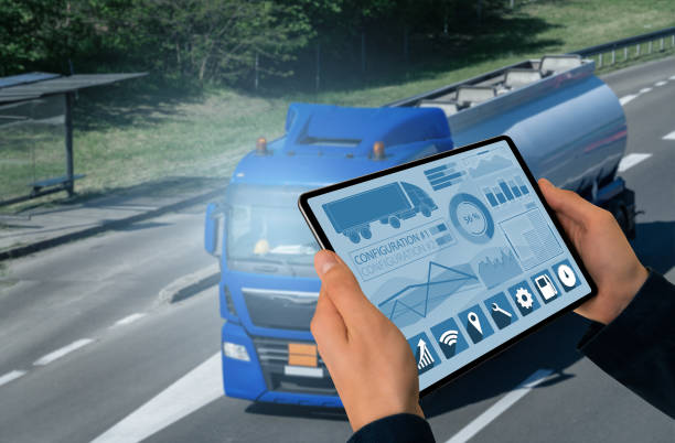 Manager with a digital tablet on the background of truck. Fleet management